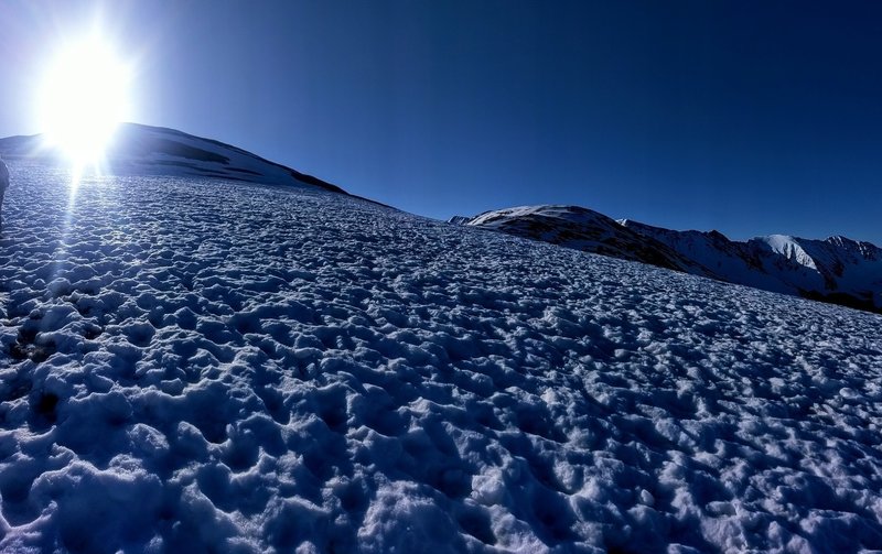 By this point, this snowfield is all that's between you and the false summit/windbreak shelters.