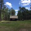 Pinchot Cabin in a clearing near the stream.