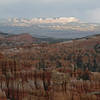 Dusk falls at Byrce Canyon as the last rays of sun illuminate The Backbone six miles away, a couple of mile northeast of the small town of Tropic