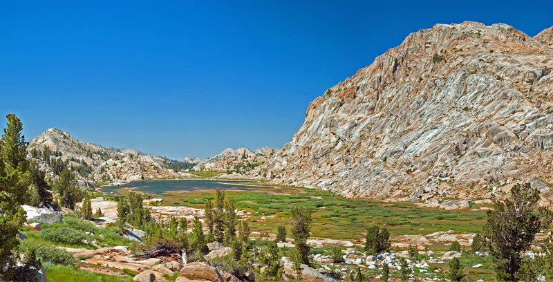 Middle Emigrant Lake. The dome on the right did not undergo normal exfoliation; instead, the seemingly polished granite has grooves and wrinkles.