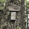 Look for the Mill Creek Lake turnoff sign nailed to this tree.