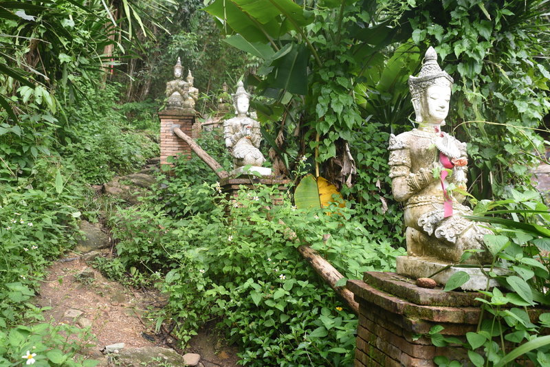 The trail is lined by statues as it approaches the monastery.