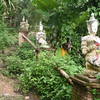 The trail is lined by statues as it approaches the monastery.