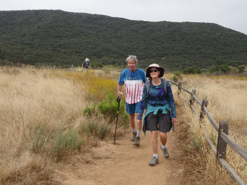 Colorful hikers enjoy Los Peñasquitos Canyon near the waterfall.