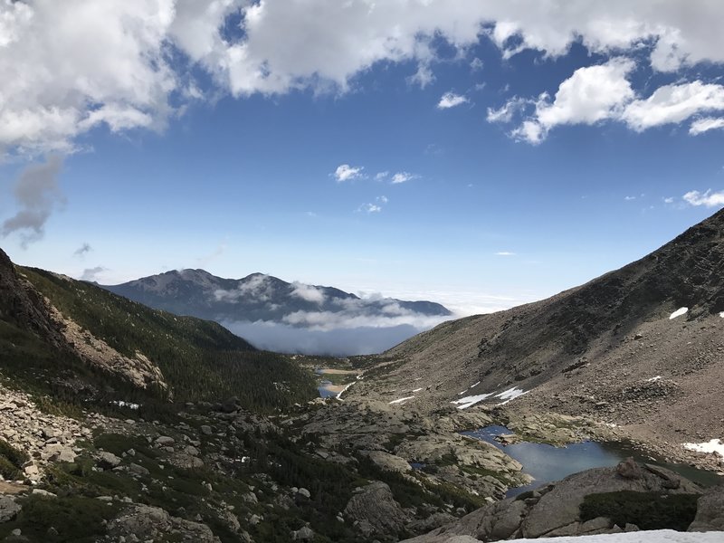 Enjoy looking down Mills Moraine at Twin Sisters Peaks from below Chasm Lake.