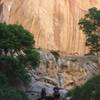 Two hikers wade through Lower Death Hollow.