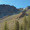 This is Chaos Crags. A rockslide (dust cloud in upper center) is coming down. Chaos Crags is a cluster of six dome volcanoes that last erupted about 1,000 years ago.