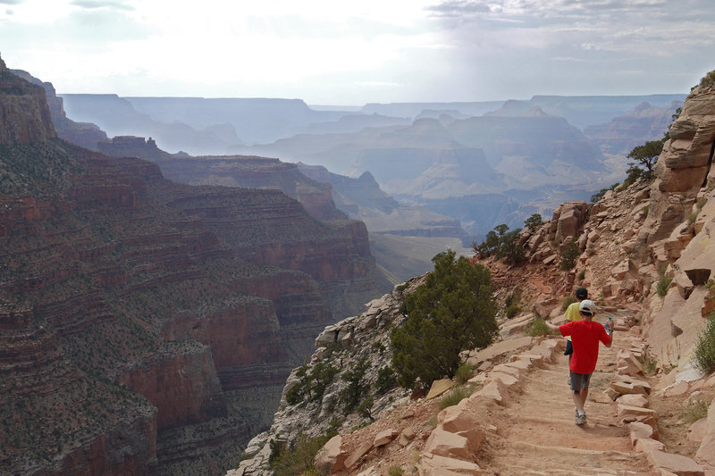 Two young hikers take in the majesty of the Grand Canyon from the South Kaibab Trail.