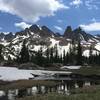 Enjoy great views of snowy mountains in July from the high meadow before the ascent up the ridge.