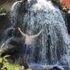 Soak in the warm shower overflow from the Three Forks Hot Springs.