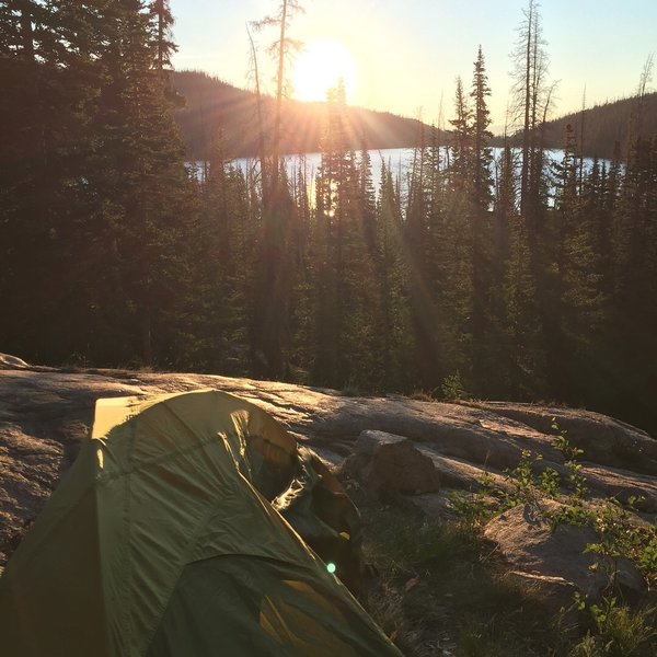 The sun rises over camp on the Rainbow Lake Trail.