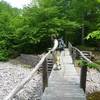 A hiker crosses the East Branch Neversink River.