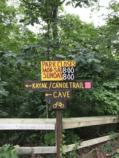 Sign at parking area showing direction to the trailhead.