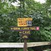 Sign at parking area showing direction to the trailhead.