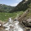 Snow melt coming out of the mini arch and waterfall just off of the trail.