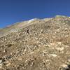 Starting the switchbacking climb to the top of Democrat on small boulders with tricky footing.