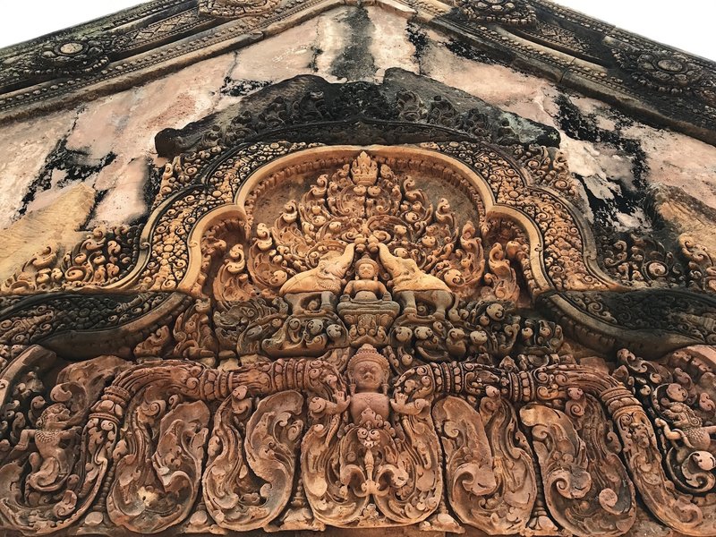 Red sandstone carvings at the entrance of Banteay Srei.