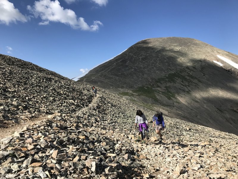 The intersection between Iowa Gulch Trail, Mount Sheridan Route, and the trail to ascend Mount Sherman. Note the braided trails up the shaded north side of Mount Sheridan.