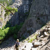 The trail opens to views of cliffs and Snoquera Falls.