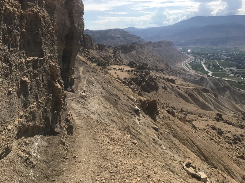 The trail skirts along a cliff before the final push to the summit plateau.  Another sketchy spot in muddy conditions