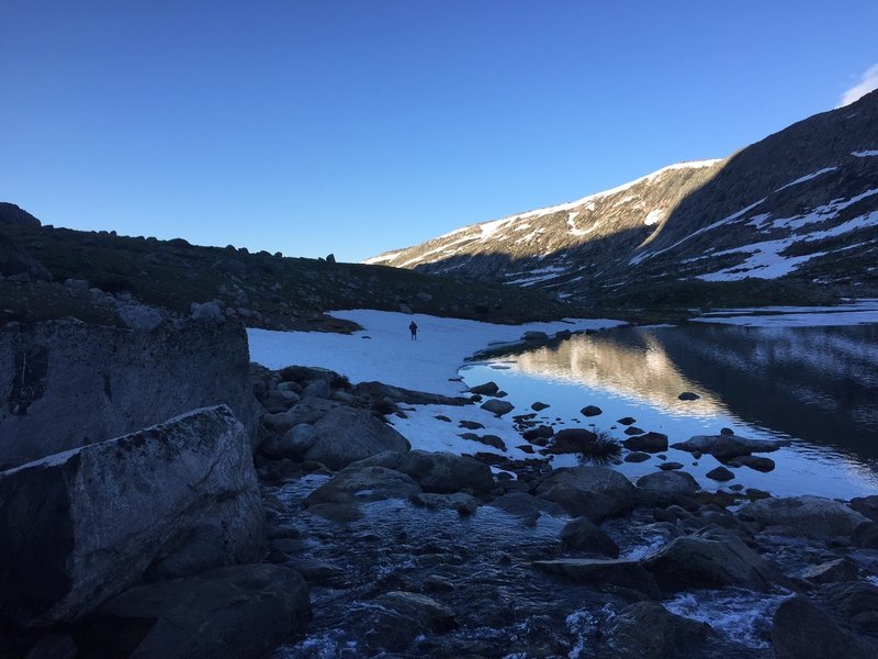 Part of the (currently snow covered) trail around Upper Titcomb Lake.