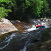 Tubers coming down the longer natural waterslide near Upper Creek Falls.