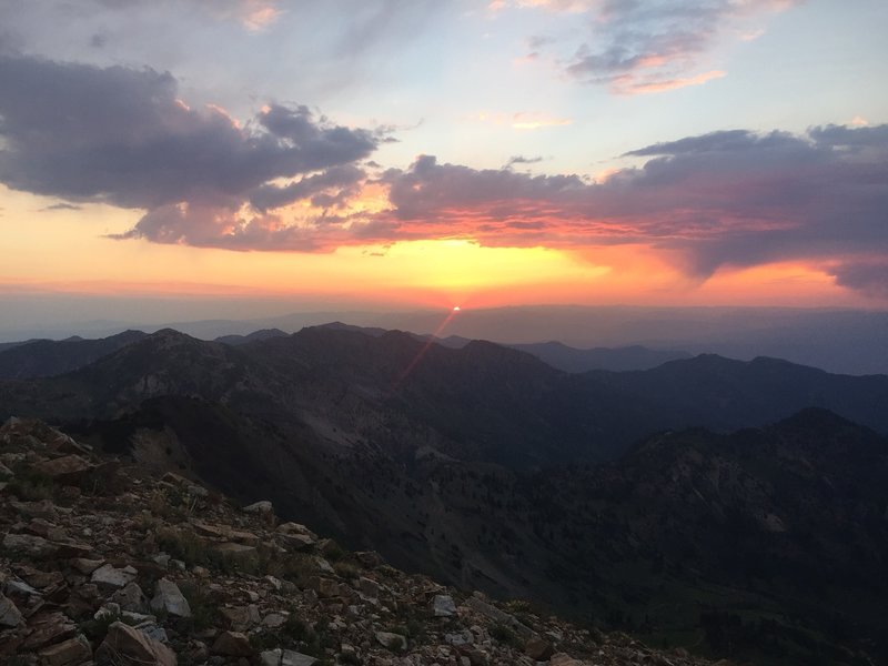 A red sunrise over the Wasatch Mountains from the ridge up toward American Fork Twin peaks
