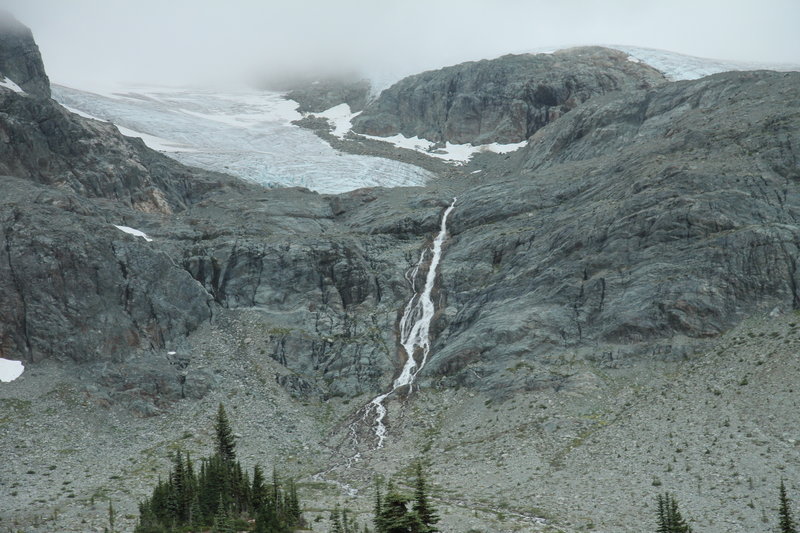 Train Glacier and waterfall from Semaphore Lakes, with fog covering mountains.