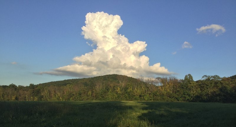 Snow white cloud over mountain.