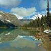 Mountains surrounding Sherbrooke Lake are mirrored in Sherbrooke Lake, looking north on a bright September morning