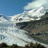 Robson Glacier flows down from Mt. Robson (right). Resplendent Mountain is in the distance on the left. Looking ahead (east-southeast) on Snowbird Pass Route.