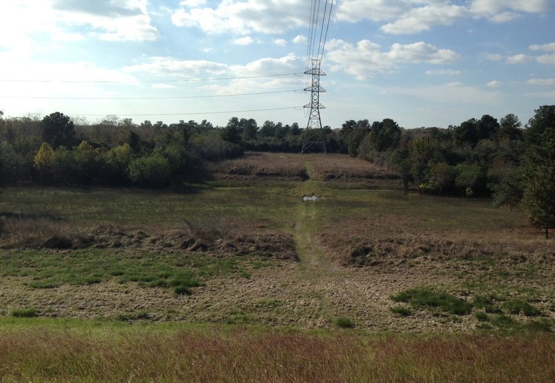 North end of the Power Line Ponds Trace looking west from the top of the dam.  The creek can generally be crossed if the reservoir is empty and if there have been no recent rains.