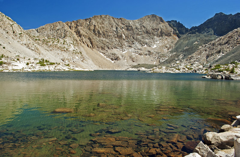 Lake 10918 below Emerald Peak. It is possible to scramble up the dark rock at the far end of the this lake to another lake above 11200 feet directly below the vertical cliffs of Emerald Peak.