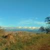 The Diablo Range is in the distance to the northeast, as seen from a rocky grass ridge of Los Cerritos Trail.