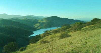 Calero Reservoir, and the Santa Cruz Mountains in the distance with Mt. Umunhum on the left, looking west-southwest from high on Los Cerritos Trail