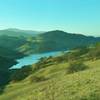 Calero Reservoir, and the Santa Cruz Mountains in the distance with Mt. Umunhum on the left, looking west-southwest from high on Los Cerritos Trail