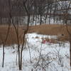 POND under the snow with red rescue ladder in case someone falls through ice.