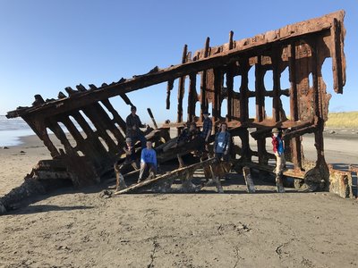 A group poses on the wreck.