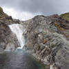 The Lake Surprise trail scrambles up the rocks to the right of this waterfall