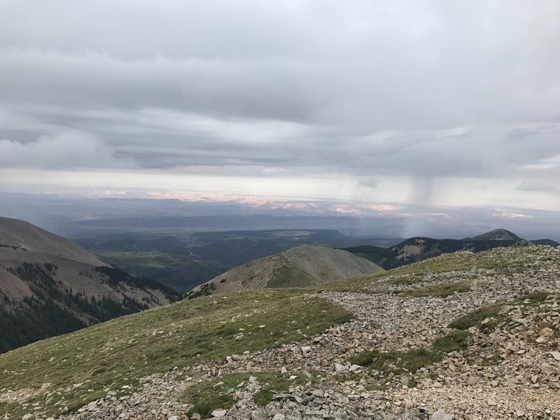 Summer storm off in the distance. View from the summit of Manns Peak