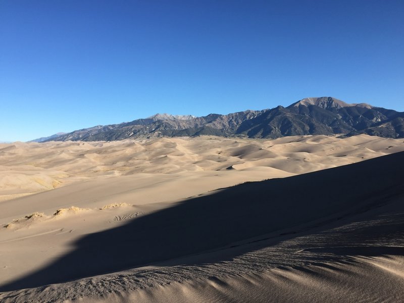 The juxtaposition of the dunes and the mountain is transfixing