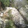 A flowing waterfall among oaks, junipers, and pines just off the trail in Romero Canyon