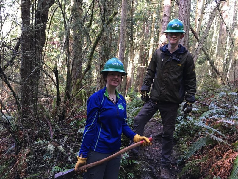 Two trail builders pose on the trail.