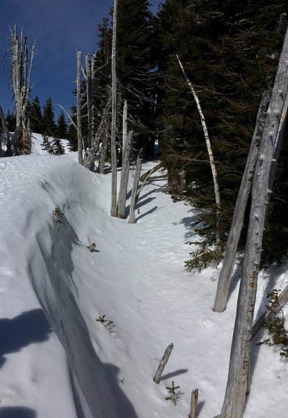 A deep snow crevasse off the path.