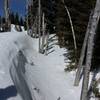 A deep snow crevasse off the path.