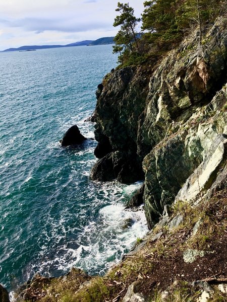 Waves crashing against the cliff side.