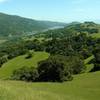 Left to right - Palassou Ridge, Coyote Lake and dam, Coyote Ridge, and southern Santa Clara Valley with central California in the far distance, looking southeast from the high point of Ed Willson Trail.