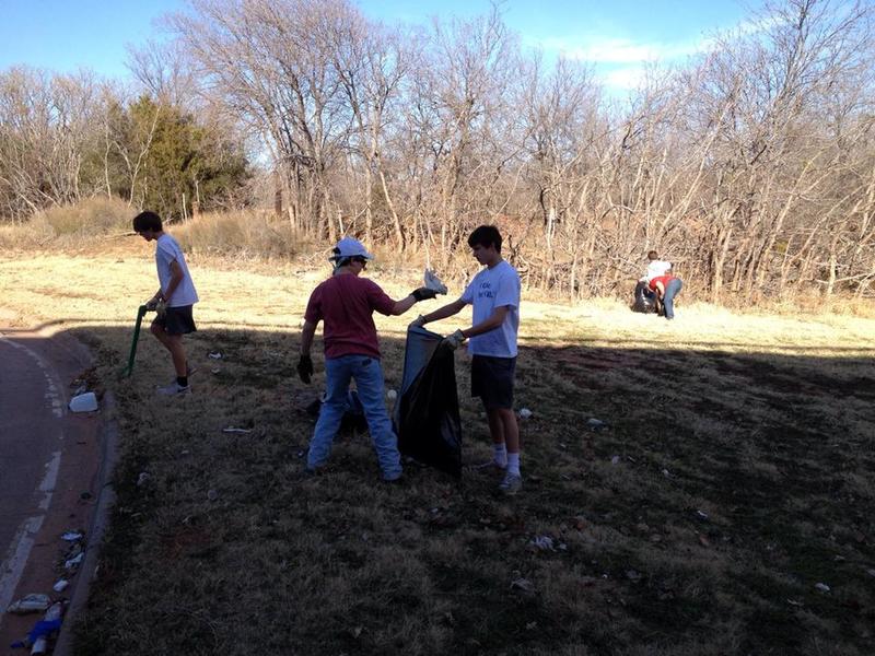 Scouts picking up trash before an event.