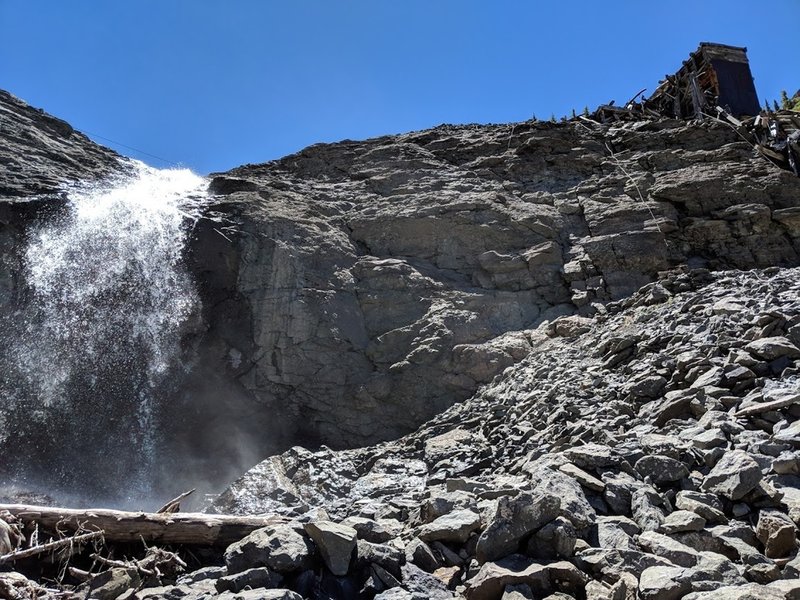 Small waterfall and old mining building