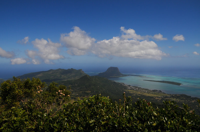Excellent views south from the summit. The prominent rock surrounded by reefs is Le Morne Brabant, and UNESCO site with a tragic history.